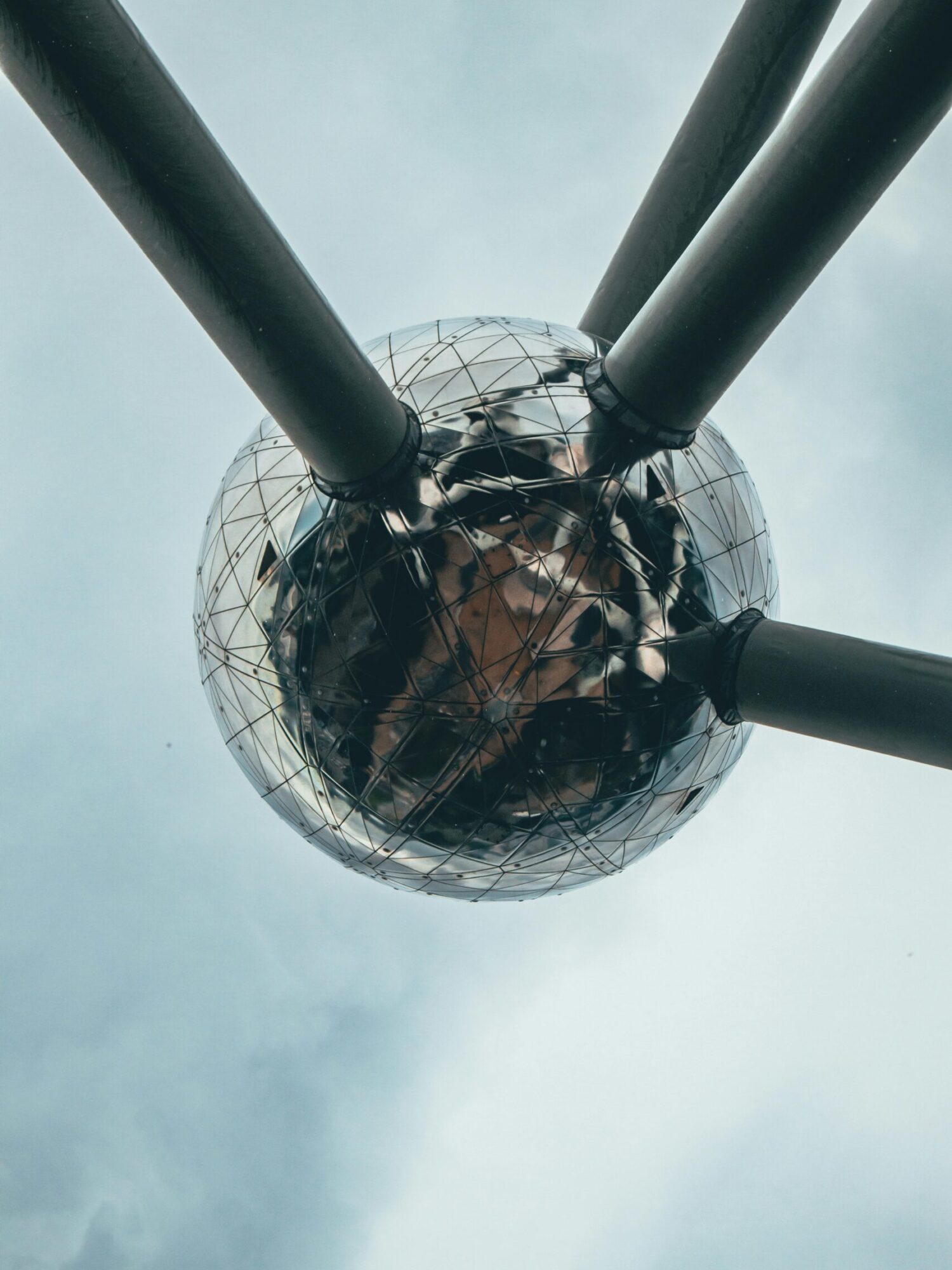 pexels-photo-18158653-18158653 Low angle shot of the iconic Atomium in Brussels with cloudy skies, showcasing its modern design.